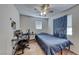 Functional bedroom with a ceiling fan, a desk, and a comfortable bed; ideal for work and rest at 10332 George Hart Ct, Las Vegas, NV 89129