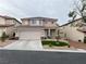 Charming two-story home with a two-car garage and xeriscaped front yard at 10332 George Hart Ct, Las Vegas, NV 89129