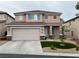 Charming two-story home with a two-car garage and xeriscaped front yard at 10332 George Hart Ct, Las Vegas, NV 89129