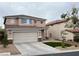 Charming two-story home with a two-car garage and xeriscaped front yard at 10332 George Hart Ct, Las Vegas, NV 89129