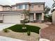 Charming two-story home with a two-car garage and low-maintenance front yard at 10332 George Hart Ct, Las Vegas, NV 89129