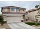 Charming two-story home with a two-car garage and xeriscaped front yard at 10332 George Hart Ct, Las Vegas, NV 89129