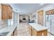 Kitchen with stainless appliances, wood cabinets, adjacent dining area, and open access to the living room at 10332 George Hart Ct, Las Vegas, NV 89129
