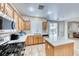 Updated kitchen featuring stainless steel appliances, tile floors, and easy access to the outdoor patio at 10332 George Hart Ct, Las Vegas, NV 89129
