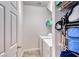 Efficient laundry area with a side-by-side washer and dryer, plus storage shelves at 10332 George Hart Ct, Las Vegas, NV 89129