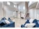 Bright, airy living room with high ceilings, tile flooring and large windows offering natural light at 10332 George Hart Ct, Las Vegas, NV 89129