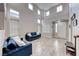 Elegant living room with soaring ceilings, large windows, and tile flooring at 10332 George Hart Ct, Las Vegas, NV 89129