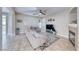 Bright living room with neutral decor, tile floors, modern ceiling fan, and a cozy fireplace at 10332 George Hart Ct, Las Vegas, NV 89129