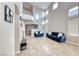 Elegant living room with soaring ceilings, large windows, and tile flooring at 10332 George Hart Ct, Las Vegas, NV 89129