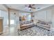 Cozy living room with tile floors and view to kitchen, perfect for entertaining at 10332 George Hart Ct, Las Vegas, NV 89129
