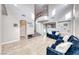 Elegant living room with soaring ceilings, large windows, and tile flooring at 10332 George Hart Ct, Las Vegas, NV 89129