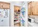 Organized walk-in pantry with shelving, door mounted storage baskets, and ample storage for food and kitchen essentials at 10332 George Hart Ct, Las Vegas, NV 89129