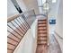 Carpeted staircase with wood and iron railing and pendant lighting overhead at 10332 George Hart Ct, Las Vegas, NV 89129