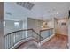 Upstairs landing featuring neutral walls, carpet, and a decorative railing at 10332 George Hart Ct, Las Vegas, NV 89129
