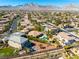 An aerial view of a neighborhood showcasing many homes with mountain views in the background at 11504 White Cliffs Ave, Las Vegas, NV 89138