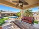 A luxurious backyard offers a covered patio, swimming pool, and plush landscaping for relaxing outdoor living at 11504 White Cliffs Ave, Las Vegas, NV 89138