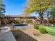 A fully landscaped backyard offers a sunken trampoline, putting green, and desert landscaping at 11504 White Cliffs Ave, Las Vegas, NV 89138