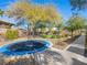 The backyard offers a sunken trampoline and mature trees, creating a peaceful oasis at 11504 White Cliffs Ave, Las Vegas, NV 89138