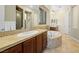 Primary bathroom with dual sinks, tub, tiled countertops, and a glass shower at 11504 White Cliffs Ave, Las Vegas, NV 89138