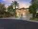 Stunning two-story home with a three-car garage, desert landscaping, and a circular driveway at 11504 White Cliffs Ave, Las Vegas, NV 89138