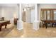 Inviting foyer with tiled floors, arched entryways and staircase access to upper level at 11504 White Cliffs Ave, Las Vegas, NV 89138
