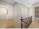Upper level landing featuring tile flooring, a decorative railing, and natural light at 11504 White Cliffs Ave, Las Vegas, NV 89138