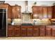 Gourmet kitchen with stainless steel appliances, granite countertops, and custom cabinetry at 11504 White Cliffs Ave, Las Vegas, NV 89138