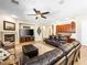 Spacious living room with leather sofas, a ceiling fan, a fireplace, and built-in cabinets at 11504 White Cliffs Ave, Las Vegas, NV 89138