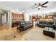 Inviting living room featuring leather sofas, a ceiling fan, and built-in cabinetry at 11504 White Cliffs Ave, Las Vegas, NV 89138