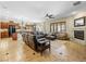 Open-concept living room with a fireplace, tile floors, and a large leather sectional sofa at 11504 White Cliffs Ave, Las Vegas, NV 89138