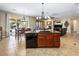 Open-concept living area with a kitchen island, dining table, and comfortable living room furniture at 11504 White Cliffs Ave, Las Vegas, NV 89138