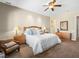 Relaxing main bedroom featuring neutral tones, ceiling fan, and hardwood furniture at 11504 White Cliffs Ave, Las Vegas, NV 89138