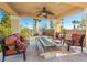 The covered patio features a ceiling fan and a built-in fire pit, ideal for entertaining or relaxing outdoors at 11504 White Cliffs Ave, Las Vegas, NV 89138