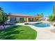 The sparkling swimming pool and lush landscaping create a private and luxurious backyard retreat at 11504 White Cliffs Ave, Las Vegas, NV 89138