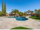 Beautiful freeform pool with rock waterfall feature and gazebo in a landscaped backyard at 11504 White Cliffs Ave, Las Vegas, NV 89138