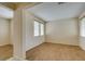 Bright living room with wood flooring, neutral walls, and large windows dressed with blinds at 1290 Corista Dr, Henderson, NV 89052