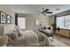 Virtually staged main bedroom with neutral paint, carpet, ceiling fan, and modern decor at 1290 Corista Dr, Henderson, NV 89052