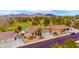 Aerial view of a well-landscaped home featuring a private pool and a golf course in the background at 1584 Bermuda Dunes Dr, Boulder City, NV 89005