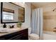 Bathroom boasts granite vanity, modern fixtures, decorative mirror, and tiled shower with tub at 1584 Bermuda Dunes Dr, Boulder City, NV 89005