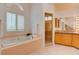 Bright bathroom featuring a soaking tub and glass shower at 1584 Bermuda Dunes Dr, Boulder City, NV 89005