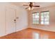 Bedroom featuring laminated wood floor, ceiling fan, and bright light through the windows at 1584 Bermuda Dunes Dr, Boulder City, NV 89005