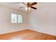 This bedroom features laminated wood floor, ceiling fan, and bright light through the window at 1584 Bermuda Dunes Dr, Boulder City, NV 89005