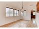 Dining room features wood floors, large windows, and a modern chandelier for a bright space at 1584 Bermuda Dunes Dr, Boulder City, NV 89005