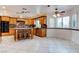 Kitchen features wooden cabinets, granite countertops, an island, and lots of natural light from large window at 1584 Bermuda Dunes Dr, Boulder City, NV 89005