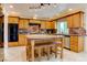 Traditional kitchen with wooden cabinets, granite countertops, and a center island at 1584 Bermuda Dunes Dr, Boulder City, NV 89005