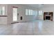 Bright living room with tiled floor, fireplace, and view to the yard through windows with white wood shutters at 1584 Bermuda Dunes Dr, Boulder City, NV 89005