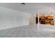 Open-concept living room with tiled floor leading to the kitchen and breakfast bar area at 1584 Bermuda Dunes Dr, Boulder City, NV 89005