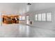 Spacious living room with view to kitchen, breakfast bar, and a window with white wood shutters at 1584 Bermuda Dunes Dr, Boulder City, NV 89005