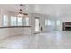 Spacious living room with tile flooring, a fireplace, and plenty of natural light through shuttered windows at 1584 Bermuda Dunes Dr, Boulder City, NV 89005