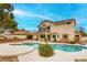 Backyard oasis features private pool with spa, covered patio, and landscaped yard at 1584 Bermuda Dunes Dr, Boulder City, NV 89005